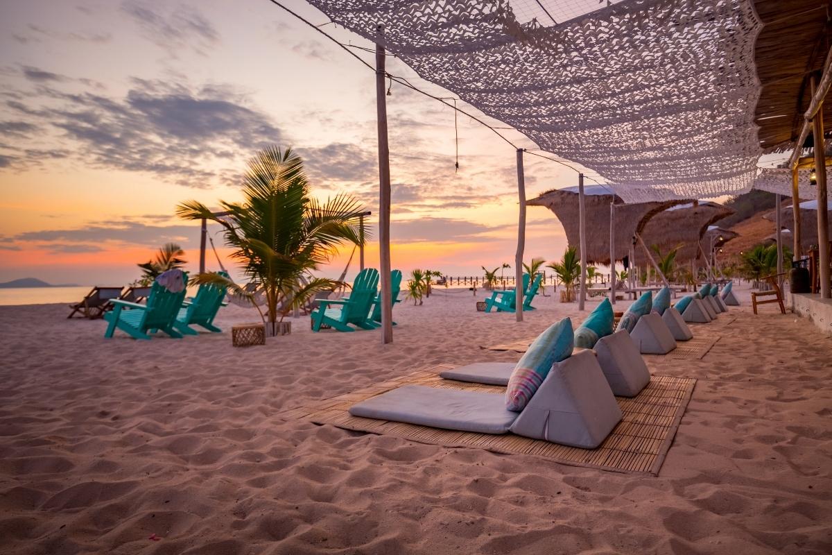 Beach club in hoi an with chairs and umbrellas on beach during sunset