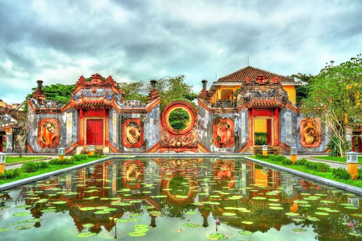 reflection view of ba mu pagoda with ornate gates and garden pond